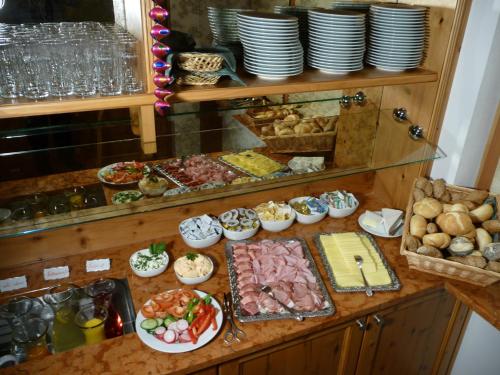 a buffet with many different types of food on a counter at Hotel Kohlpeter in Salzburg