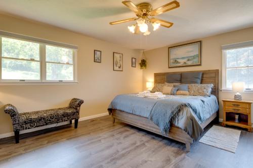 a bedroom with a bed and a ceiling fan at 11 Mi to Asheville Scenic Retreat with Game Room in Candler