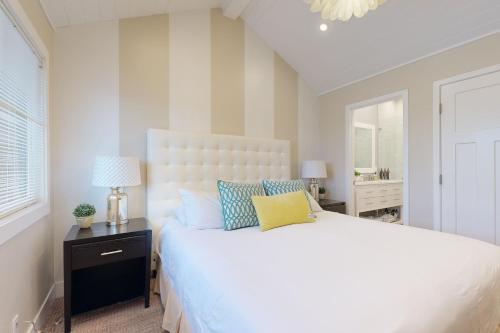 a bedroom with a large white bed and a window at On the Doorstep in Anaheim