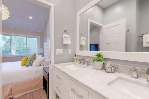 a bathroom with two sinks and a large mirror at On the Doorstep in Anaheim