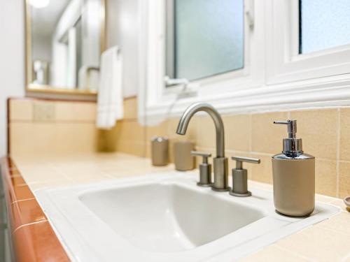 a bathroom sink with a soap dispenser on it at 6BR Pool Escape for Friends and Family - LOU1 - BUR in Burbank