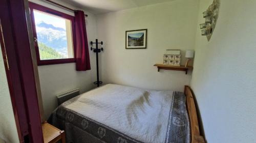 - une petite chambre avec un lit dans une pièce dotée d'une fenêtre dans l'établissement Résidence Grand Argentier - 2 Pièces pour 6 Personnes MAE-3194, à Modane