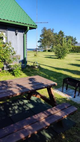 a picnic table in the grass next to a building at Mereliivatee in Neeme