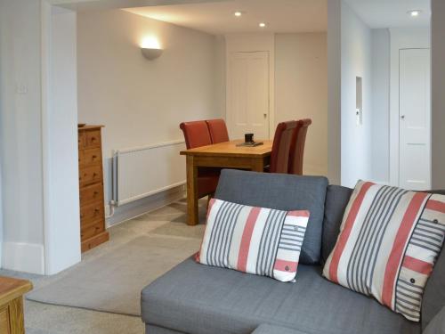 a living room with a couch and a table at Coastguard Cottage in Ryde