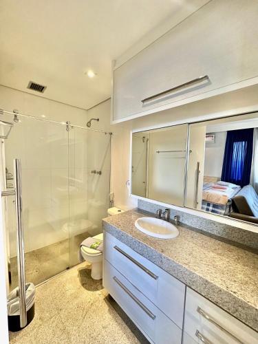 a bathroom with a sink and a shower and a toilet at Bienal Suites Ibirapuera c/ Sacada - UH 1207 in São Paulo