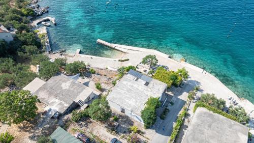 an aerial view of a house next to the water at Apartments by the sea Cove Pjestata, Peljesac - 10236 in Blaževo