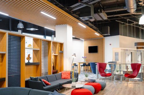 a lobby with a couch and chairs and a table at Holiday Inn Express - Birmingham - City Centre by IHG in Birmingham