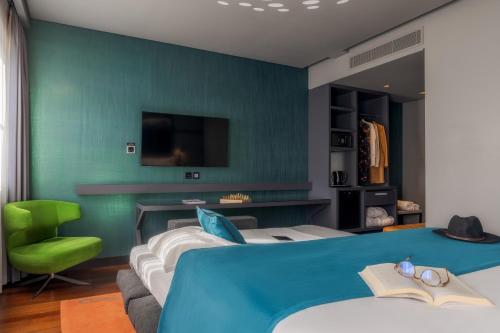 a bedroom with a bed and a green wall at Pestana CR7 Lisboa in Lisbon