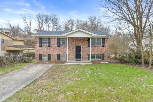 a brick house with a driveway in the yard at Hillside Haven - affordable and convenient in Chattanooga