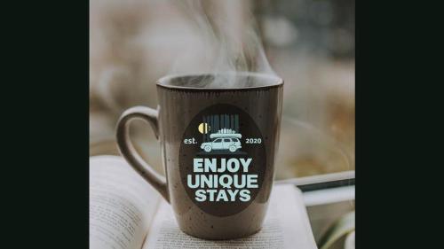 a cup of coffee sitting on top of a book at Hillside Haven - affordable and convenient in Chattanooga