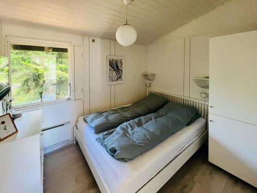 a bed in a small room with a window at Cozy Family Holiday Home By Nordstrand in Nykøbing Sjælland