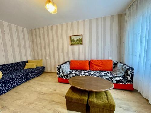 a living room with a couch and a table at Daina in Ventspils