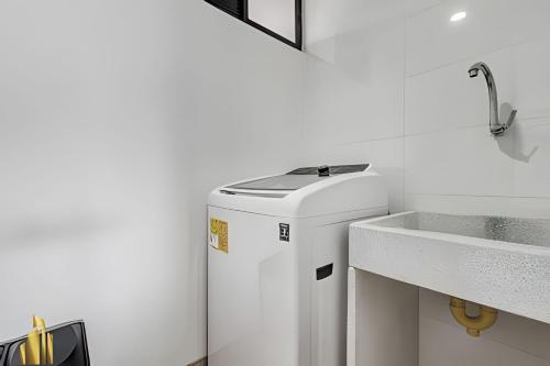 a small refrigerator in a kitchen next to a sink at Class 48 apto. 1303 - Luminoso / Vistas / Balcón in Sabaneta