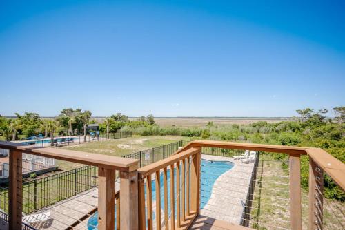 a deck with a view of a swimming pool at Lily's Pad in Oak Island