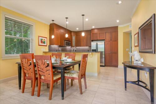 a kitchen with a dining room table and chairs at Hale Pikake in Hapuna Beach