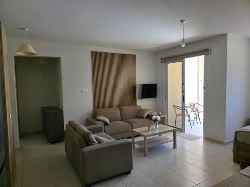a living room with a couch and a table at Tersefanou Retreat in Tersephanou