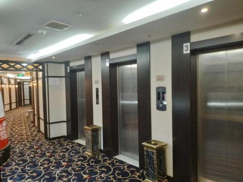 a row of elevators in a hotel lobby at فندق نزهة المشتاقين in Al Gharīth