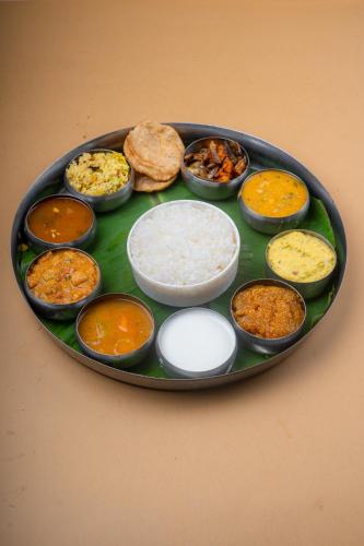 a plate of different types of food on a table at Hotel Manorama Vijayawada in Vijayawāda