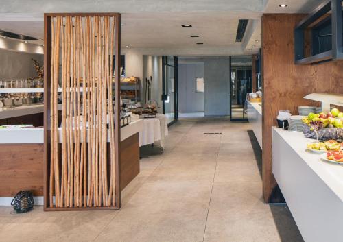 a restaurant with a buffet line with food on display at La Mer Resort Spa Crete in Georgioupolis