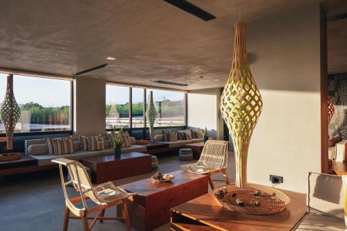 a living room with a couch and a table and chairs at La Mer Resort Spa Crete in Georgioupolis