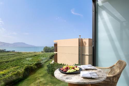 a plate of fruit on a table on a balcony at La Mer Resort Spa Crete in Georgioupolis