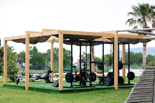 a pavilion with scooters on display in a park at La Mer Resort Spa Crete in Georgioupolis