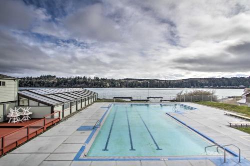 a swimming pool with a view of a lake at Water Views and Marina Access Port Ludlow Getaway in Port Ludlow