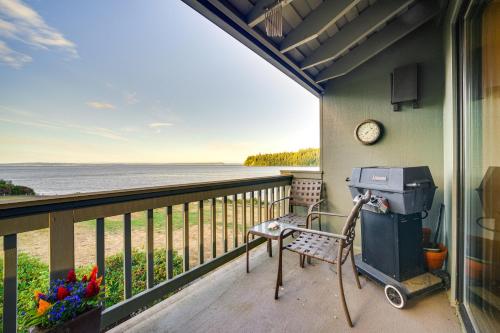 a screened in porch with a heater and a chair on the balcony at Water Views and Marina Access Port Ludlow Getaway in Port Ludlow