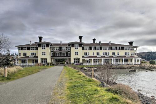 a large white house on the side of a river at Water Views and Marina Access Port Ludlow Getaway in Port Ludlow