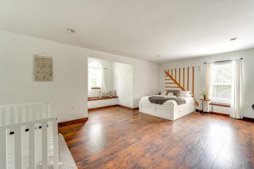 a bedroom with a bed and a wooden floor at Family Home with Deck about 2 Mi to Camelback Mountain! in Tannersville