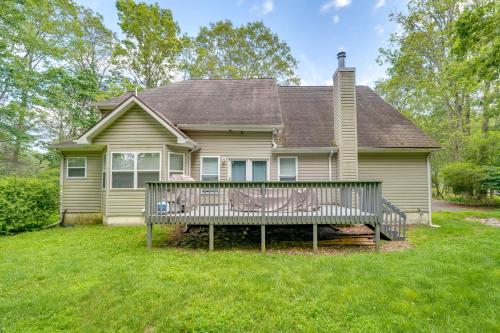 a house with a large wooden deck in the yard at Family Home with Deck about 2 Mi to Camelback Mountain! in Tannersville