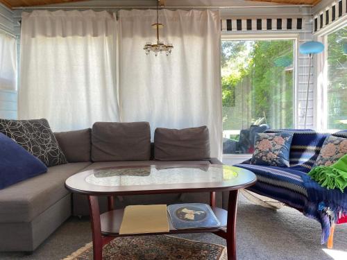 a living room with a couch and a table at 4 star holiday home in HÖLLVIKEN in Höllviken