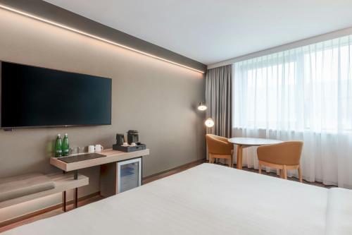 a hotel room with a bed and a table at AC Hotel by Marriott Bratislava Old Town in Bratislava