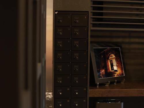 a bunch of lockers with a picture of a building at MONOMINAHOTELstn1 in Ōmuta