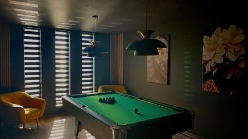 a billiard room with a pool table in it at Greyhouse Apartments in Harkány
