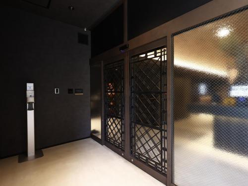 an open door to a room with a fence at MONOMINAHOTELstn1 in Ōmuta