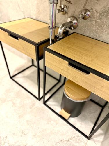 a bathroom with two wooden tables and a sink at NEU MotoLoft Schwarzwaldhochstraße Zentrum Goldstadt Pforzheim Schlössle in Pforzheim