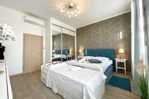 a bedroom with two beds and a chandelier at Holiday home in Crikvenica 5589 in Crikvenica