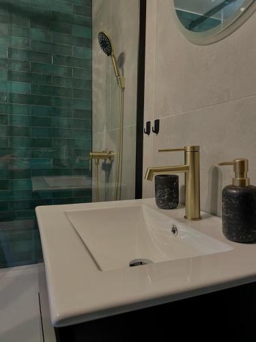 a bathroom with a white sink and a shower at Chalet in the Slovak Paradise in Hnilčík