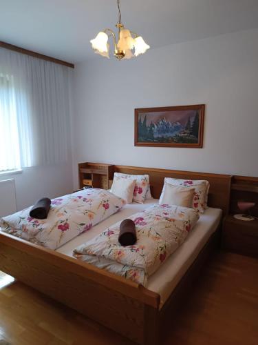a bedroom with a bed with two pillows at River Pearl - Garnitzenklamm in Möderndorf