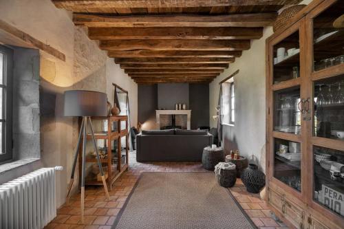 a living room with a wooden ceiling and a couch at Domaine la valette in Thollet