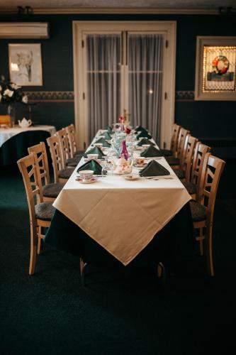 a long table in a dining room with chairs at Stonehurst Manor Breakfast & Dinner Included in North Conway