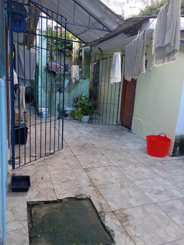 an iron gate with clothes hanging on a wall at Trem Bão de Dormir in Recife