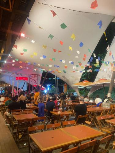a group of people sitting at tables in a restaurant at Hostel do Meio in Salvador