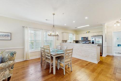 a kitchen and dining room with a table and chairs at Gardens at Cypress Bay 19-104 in Little River