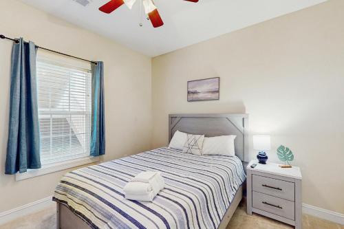 a bedroom with a bed and a window at Gardens at Cypress Bay 19-104 in Little River