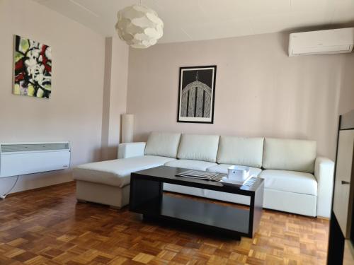 a living room with a white couch and a coffee table at Alex Bl in Banja Luka