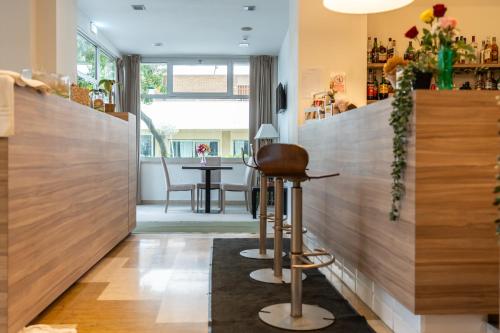 a bar with wooden walls and a stool at Hotel Majorca sul Mare in centro a Riccione con Area Fitness in Riccione