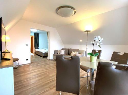 a living room with a table and a couch at Süderhaus Hiddensee App 11 in Neuendorf