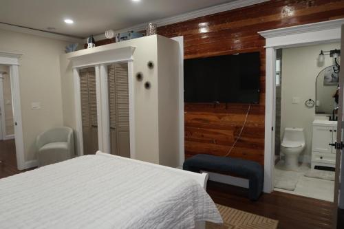 a bedroom with a bed and a flat screen tv at The Elizabeth Suite in Key West